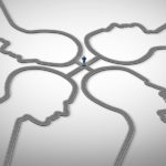 business person standing at crossroads of 4 heads