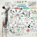 Back view of businesswoman standing on ladder and drawing financial models