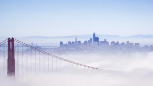 Golden Gate Bridge in fog with San Francisco Skyline