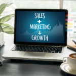 Sales + Marketing = Growth sign on laptop