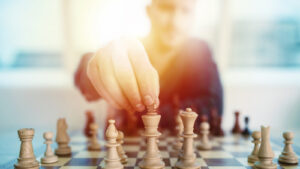 Businessman,Play,With,Chess,Game.,Concept,Of,Business,Strategy,And