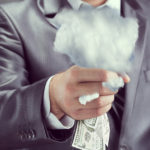 business person squeezing cloud and money