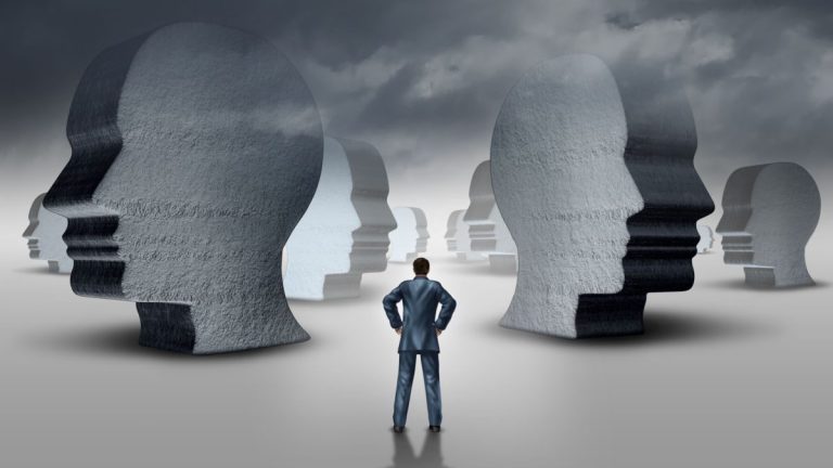 Selection partner strategy and business concept as a businessperson standing in front of a landscape with three dimensional head sculptures as symbols of employment hiring and career issues.