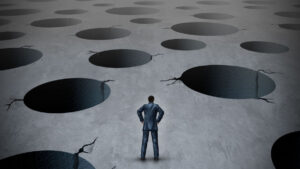 business person looking out over a field of holes