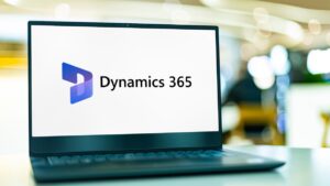 laptop on table with Microsoft Dynamics 365 logo on it